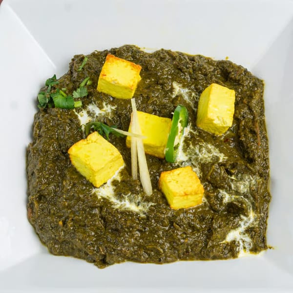 Mehran Restaurant's Palak Paneer, a Pakistani dish with spinach and paneer cheese, garnished with ginger and chili.