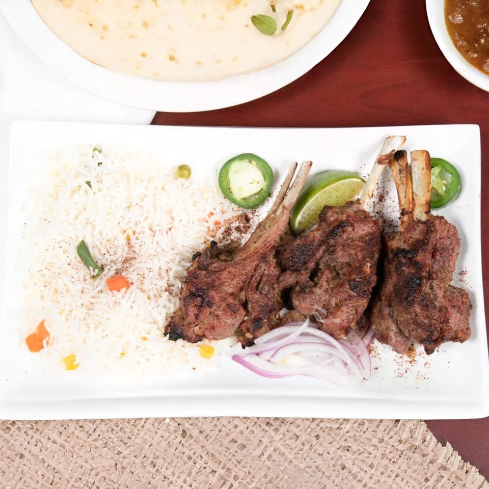 Mehran Restaurant's Pakistani lamb chops with rice, lime, jalapeños, and red onions.